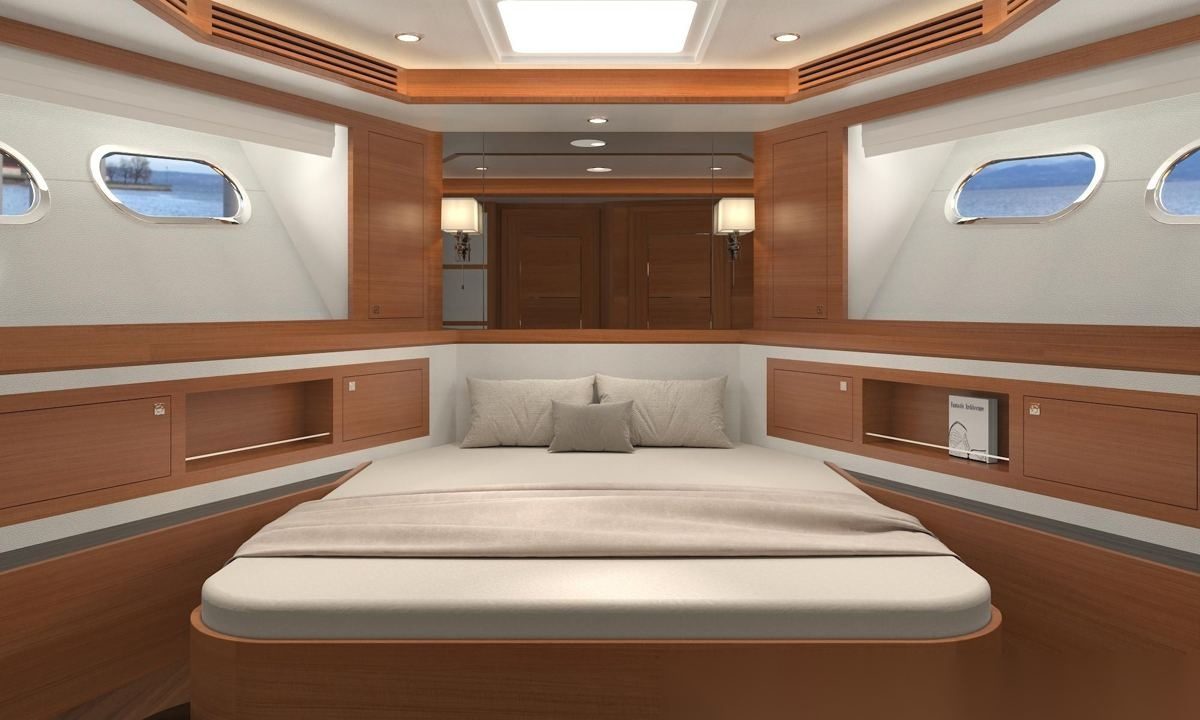 Forward cabin finished in teak, warm reddish joinery around the berth